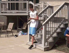 prank-water-thrown-trash-can-on-head-kicked-into-pool-13841055667.gif