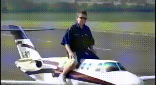 guy-riding-model-plane-sitting-on-plane-